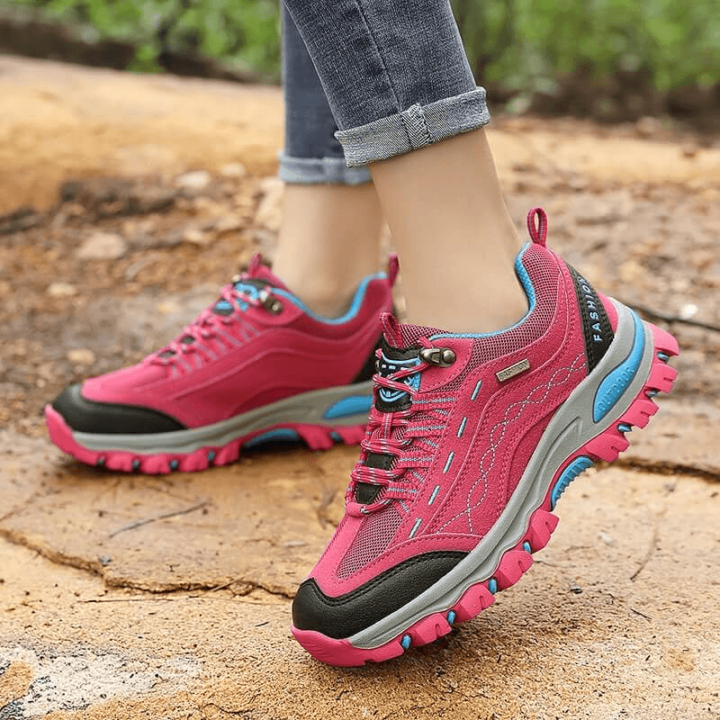 Trekking women's sneakers with lace-up for novice hikers, featuring vibrant pink design, cotton fabric upper, and rubber outsole for grip.